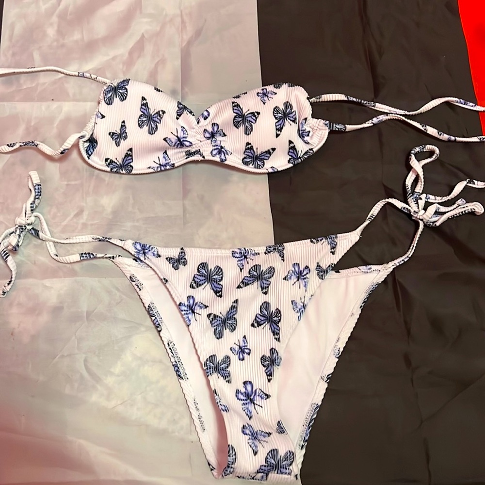 A white bikini white blue butterflies on it
